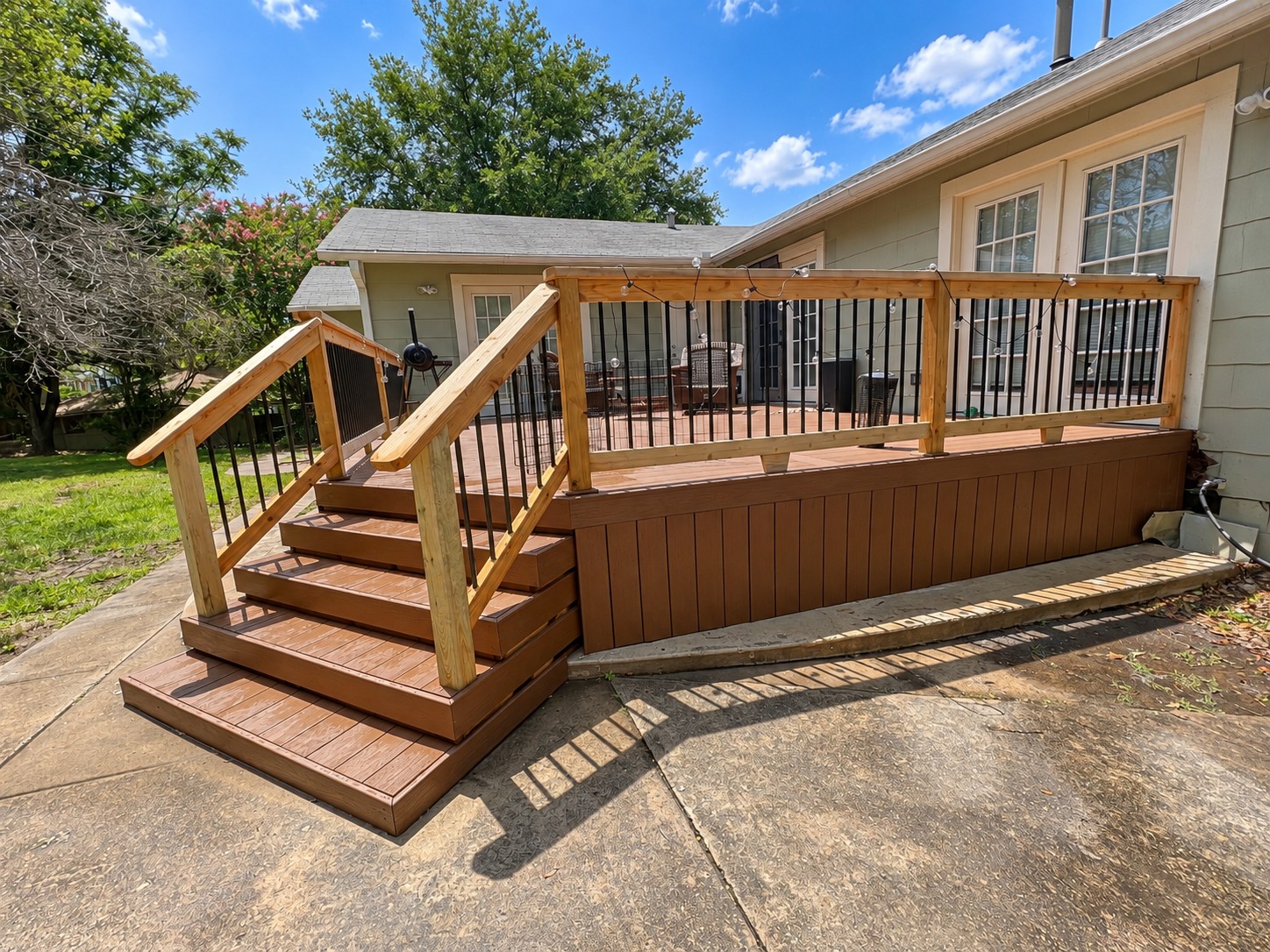 Completed wood deck and railing by Master Renovations