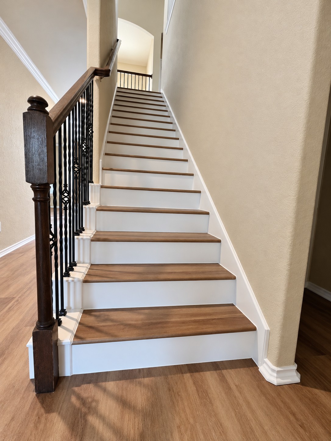 Finished staircase with white risers and wood-tone treads